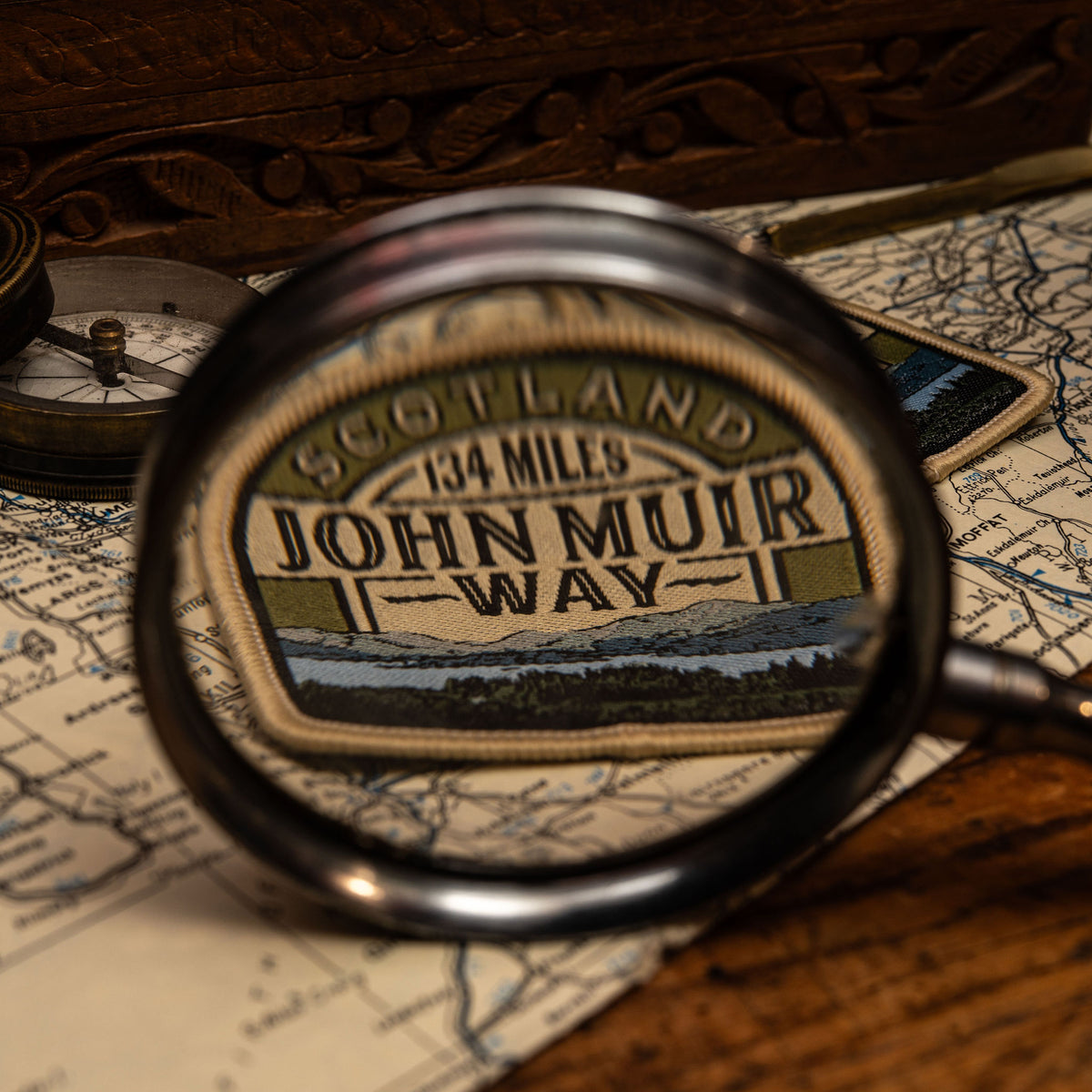 John Muir Way patch lifestyle shot on outdoor gear - retro woven Scottish trail patch