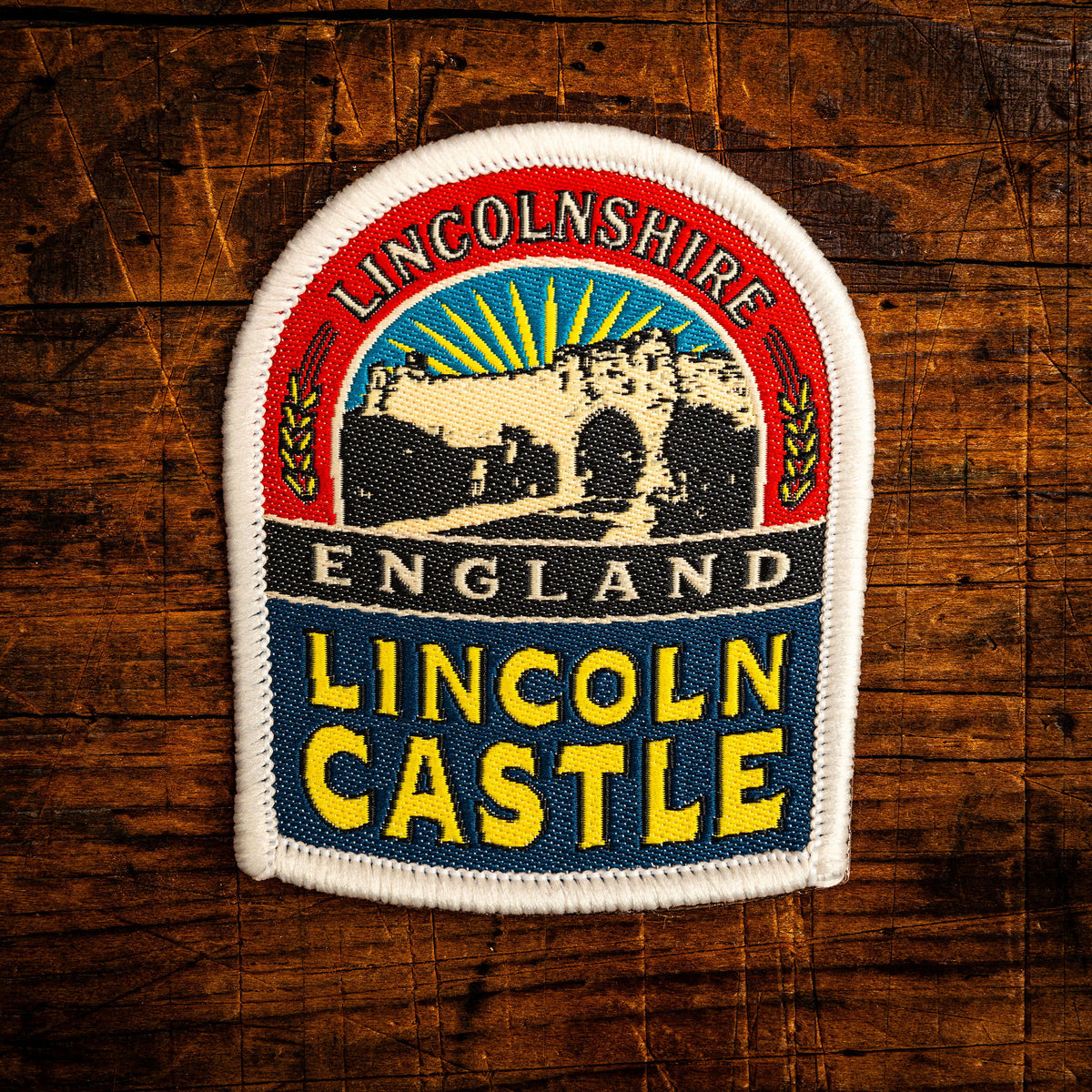 Lincoln Castle retro woven patch - historic Norman castle in Lincolnshire, pub sign design, iron-on