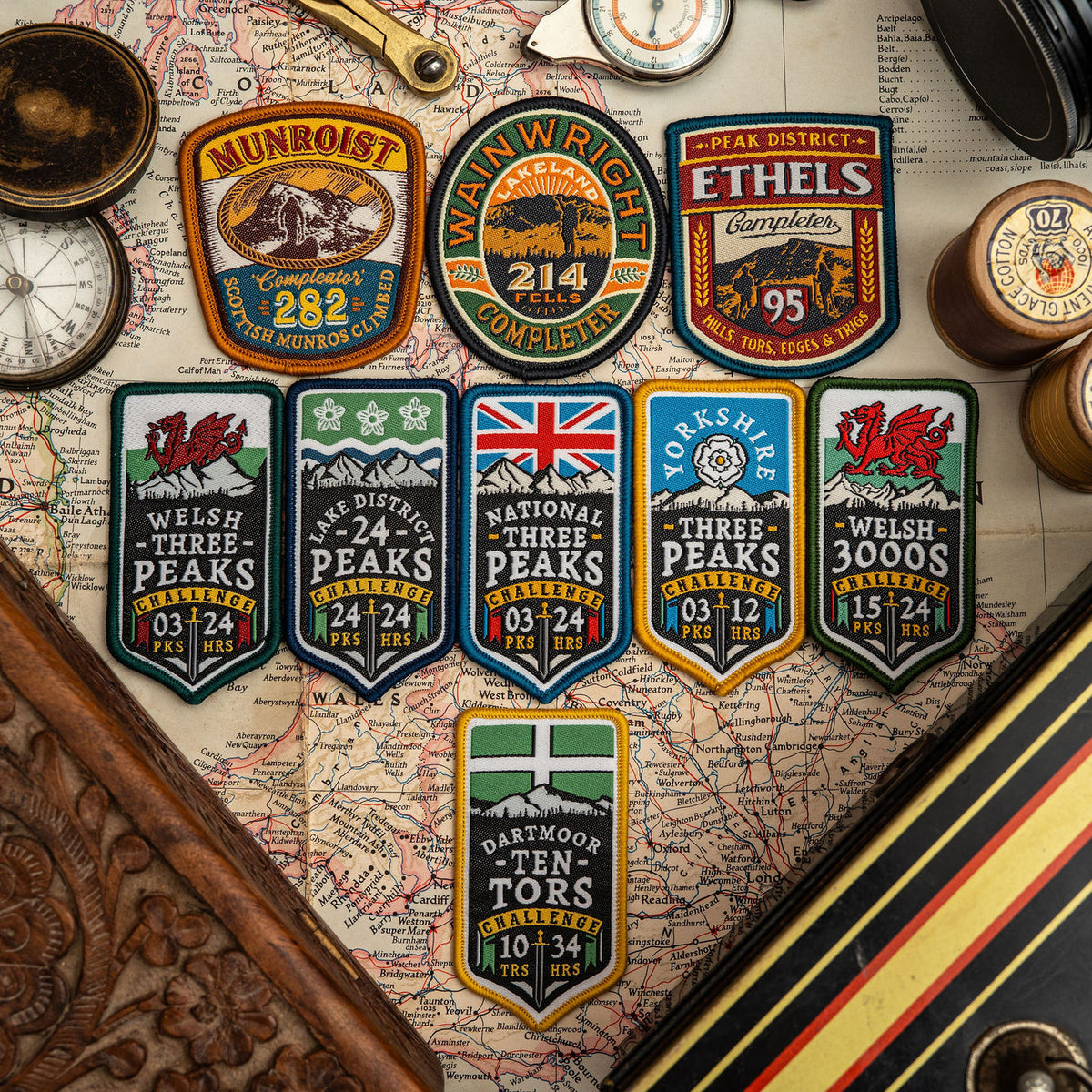 Adventure Patch Company challenge patches displayed together – woven hiking and hillwalking patches