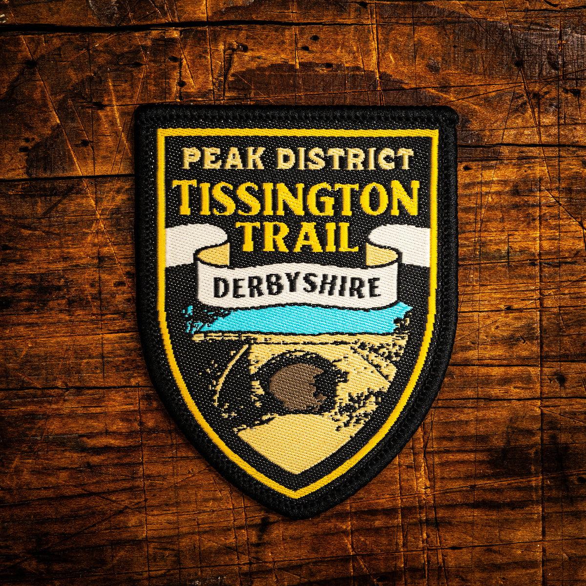Tissington Trail retro woven patch – Peak District trail along former Ashbourne-Buxton railway, pub sign design