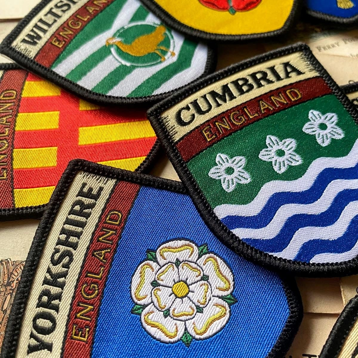 County flag patches on outdoor gear including Northumberland - retro woven patches for England