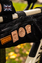 Bikepacking patches lifestyle shot on cycling gear - Trans Cambrian Way patch included