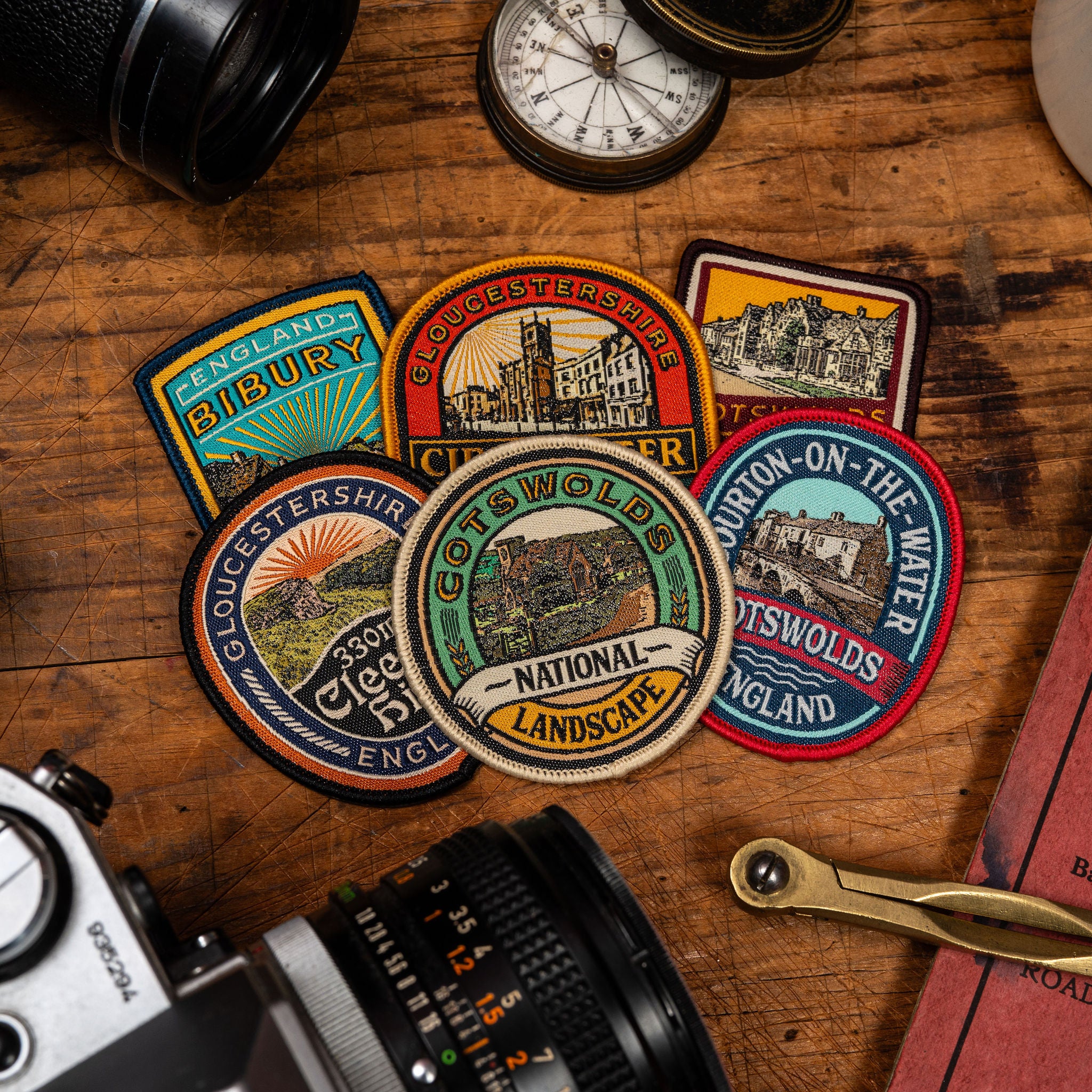 Cotswolds patches collection flat-lay - retro woven hiking patches celebrating Cotswolds hills and landmarks