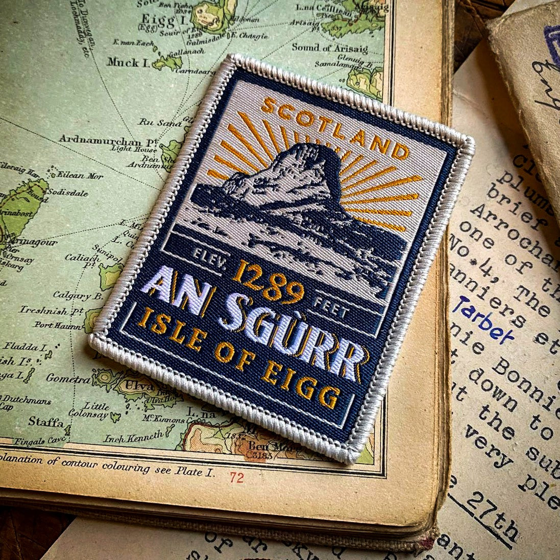 An Sgurr patch on outdoor gear - retro whisky label woven patch for Isle of Eigg climbers