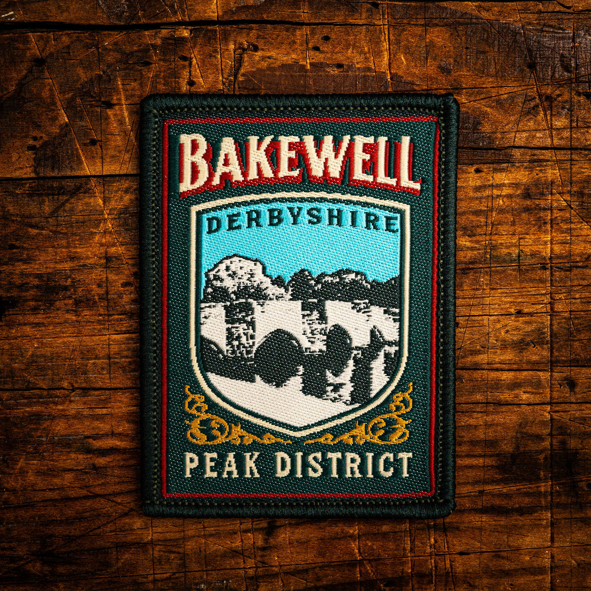 Bakewell retro woven patch – historic market town in Peak District, pub sign design, iron-on backing