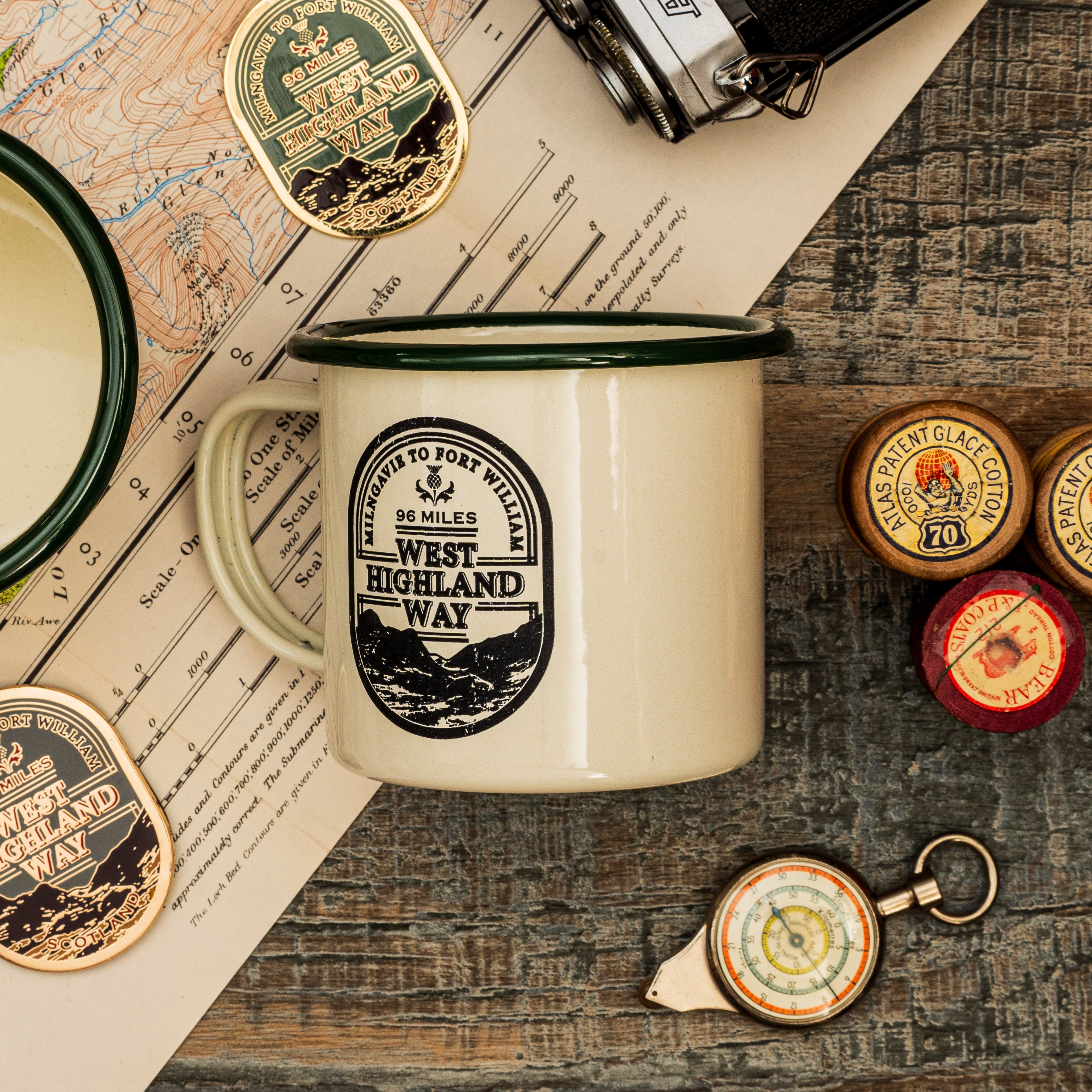 West Highland Way camp mug lifestyle shot - enamel camping mug in outdoor setting
