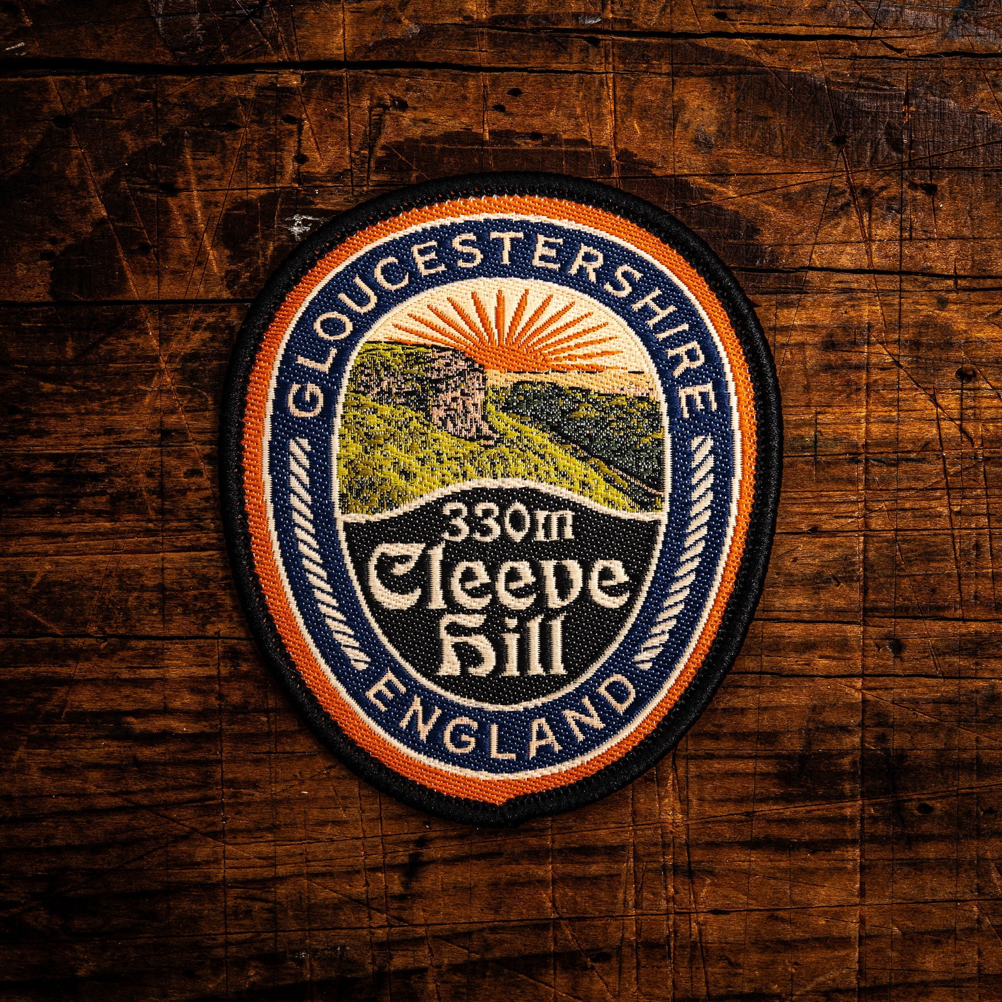 Cleeve Hill retro woven patch – highest point of the Cotswolds at 330m, iron-on backing, recycled yarn