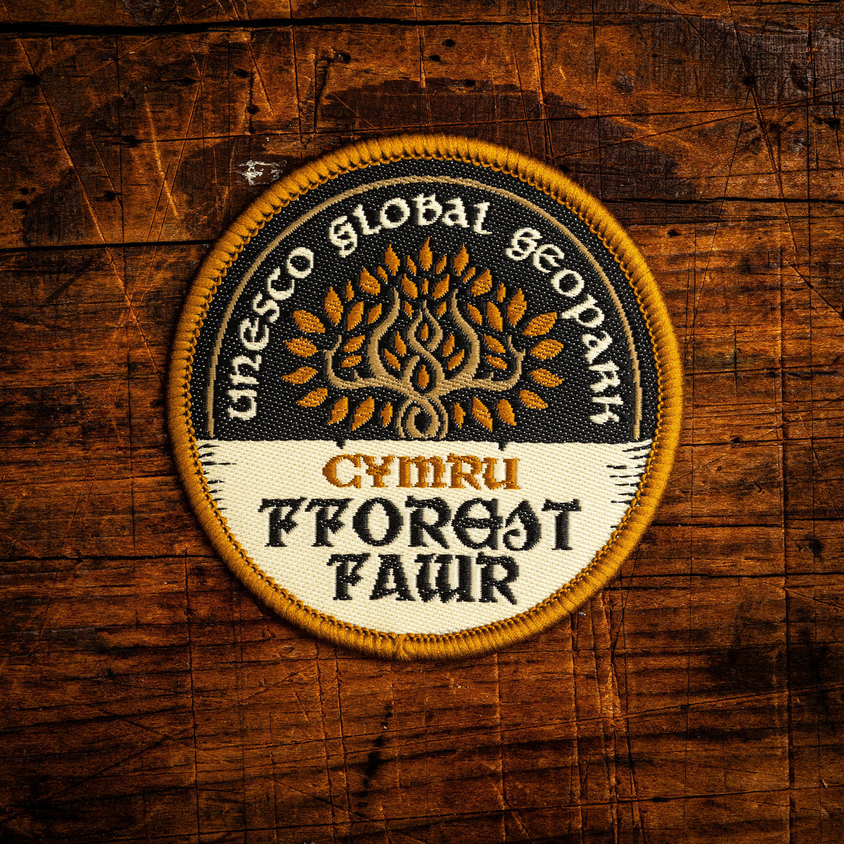 Fforest Fawr Celtic design woven patch – UNESCO Geopark in southern Wales, iron-on backing, recycled yarn