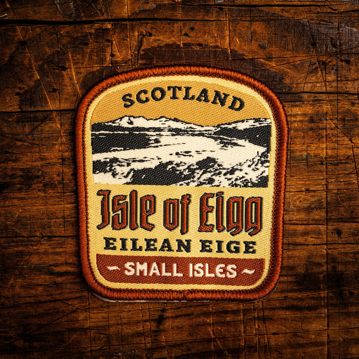 Isle of Eigg retro woven patch - beautiful Scottish island with distinctive An Sgurr, whisky label design, iron-on
