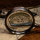John Muir Way patch lifestyle shot on outdoor gear - retro woven Scottish trail patch
