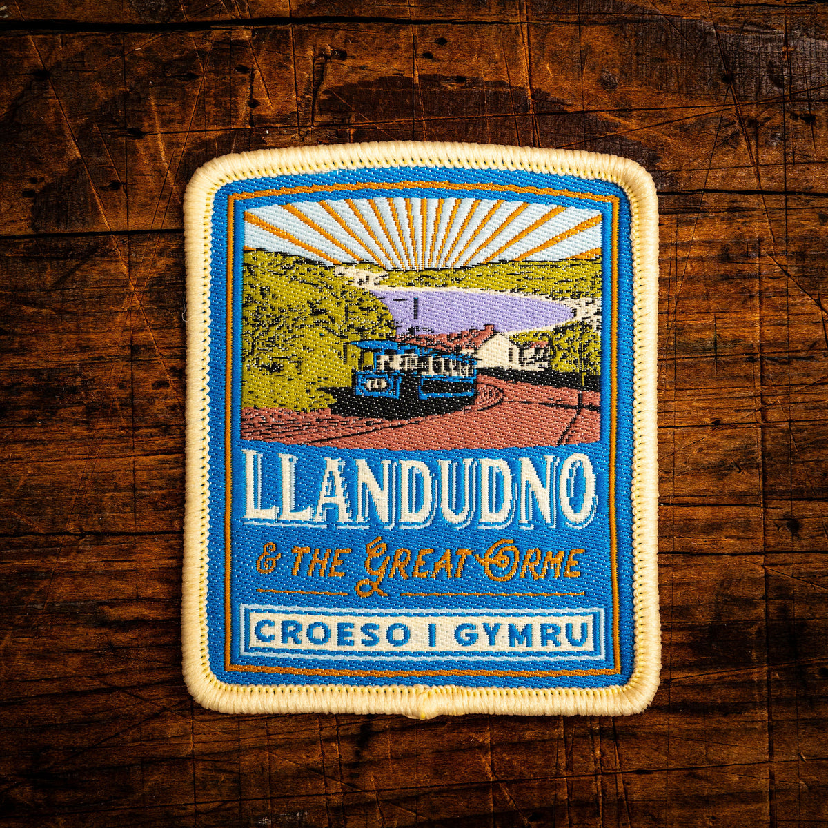 Llandudno Celtic design woven patch - popular North Wales coastal town, iron-on backing, recycled yarn