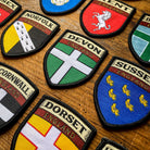 English county flag patches on outdoor gear including Dorset - retro woven county flag patches