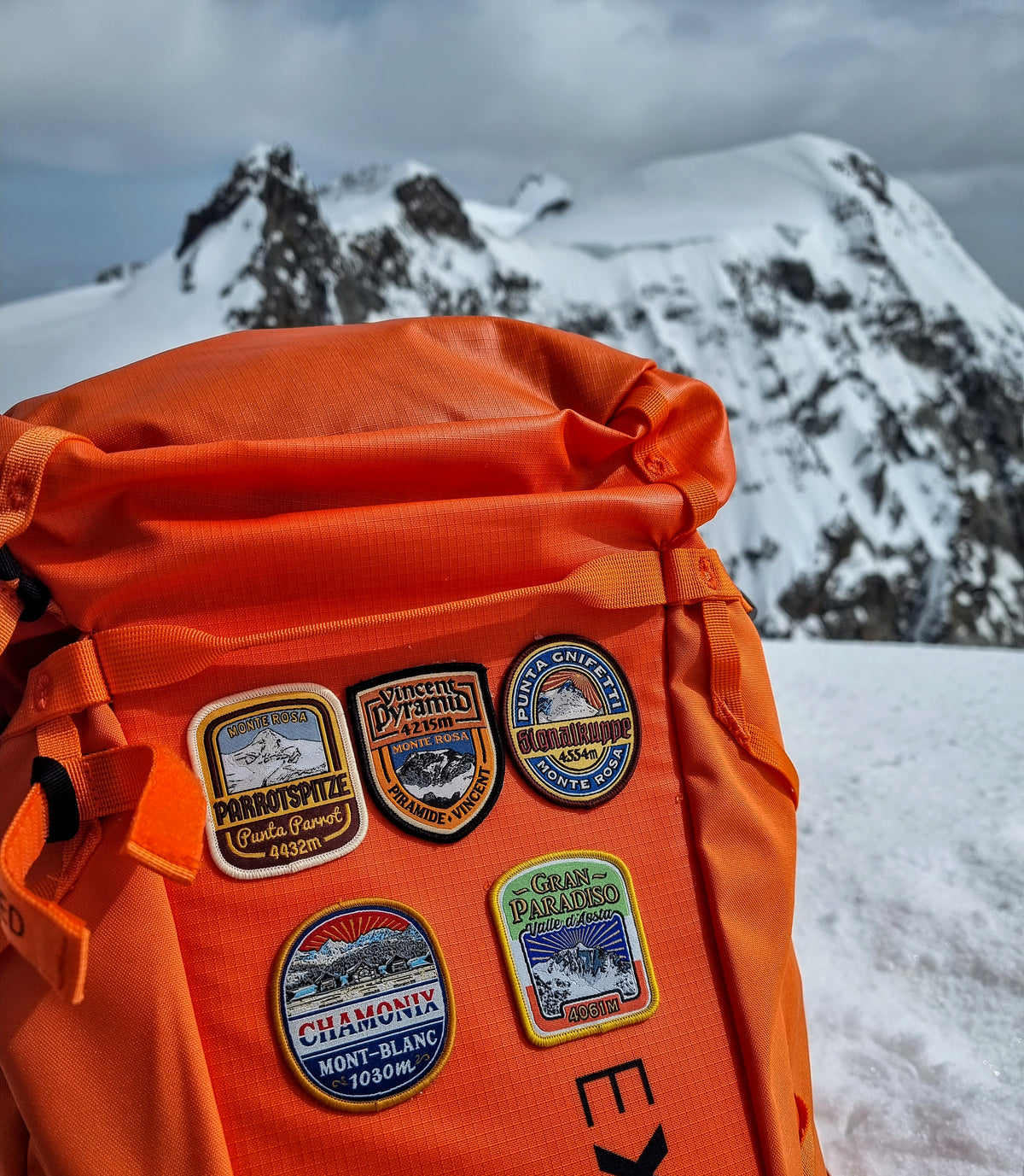 Signalkuppe patch on outdoor pack – retro woven Alpine patch in mountain setting