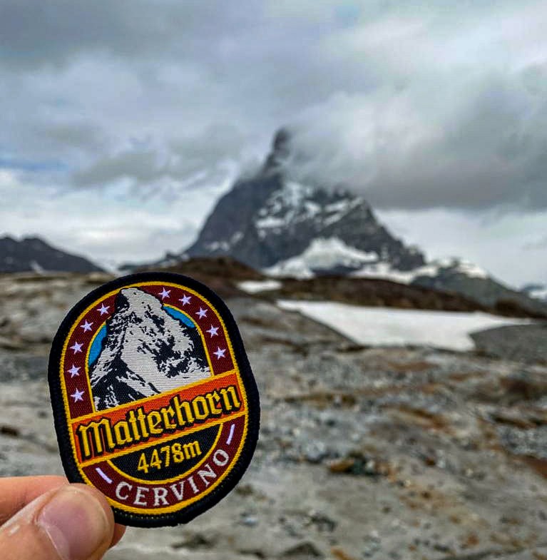 Matterhorn patch close-up on a rucksack – retro woven Alpine patch worn in mountain setting