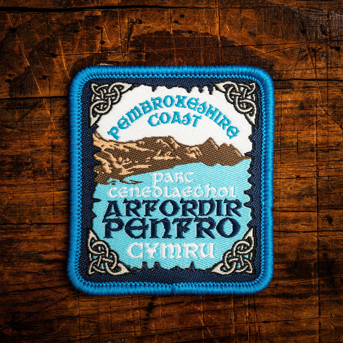 Arfordir Penfro (Pembrokeshire Coast) Celtic design woven patch – Welsh coastal national park, iron-on