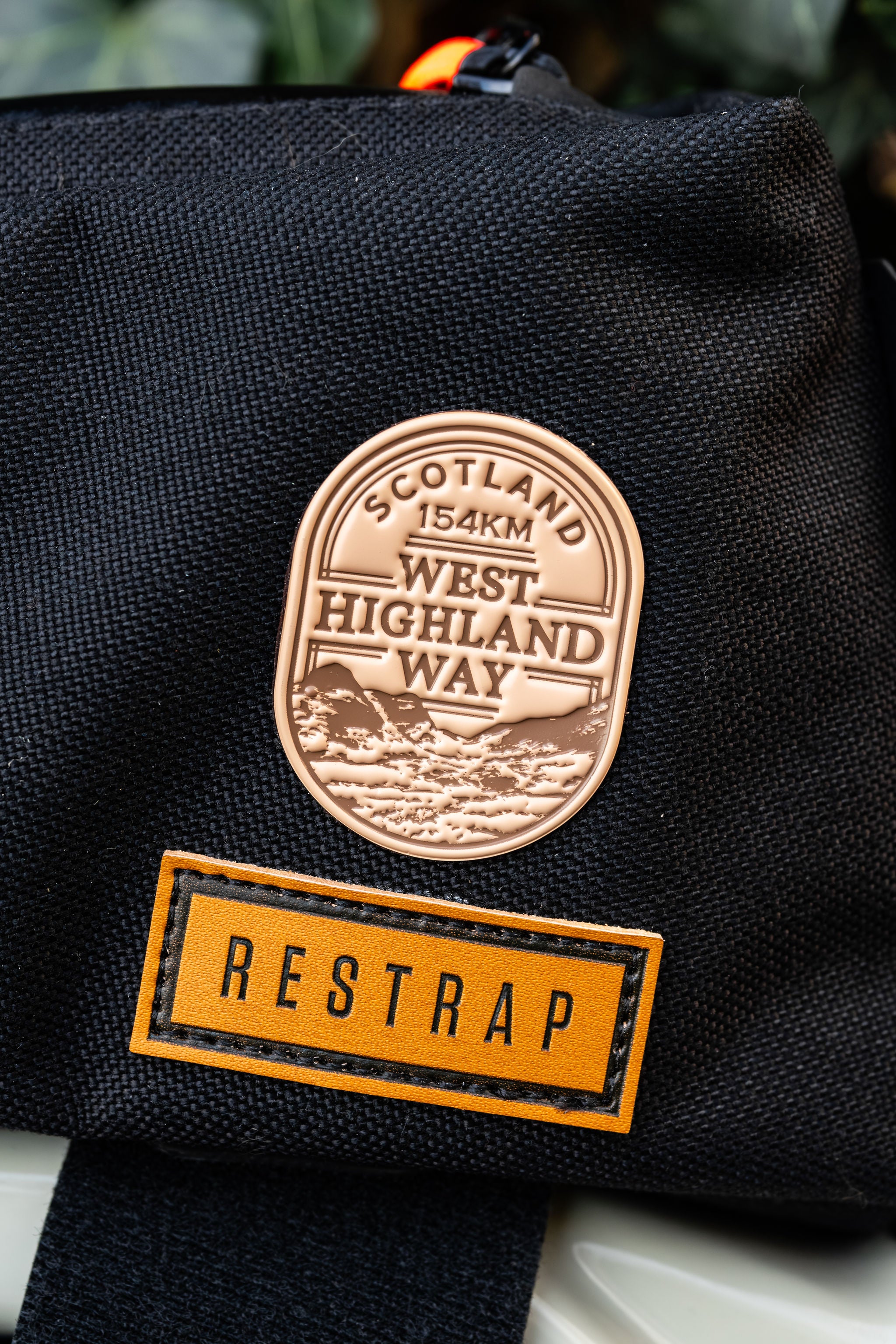 Bikepacking patches lifestyle shot on cycling gear - retro woven cycling route patches collection