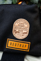 Bikepacking patches lifestyle shot on cycling gear - retro woven cycling route patches collection