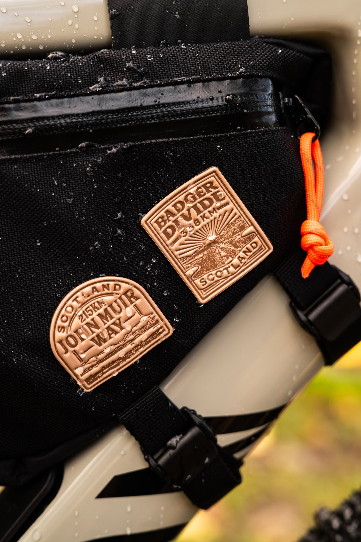 Bikepacking patches hero shot including John Muir Way - retro woven cycling route patches