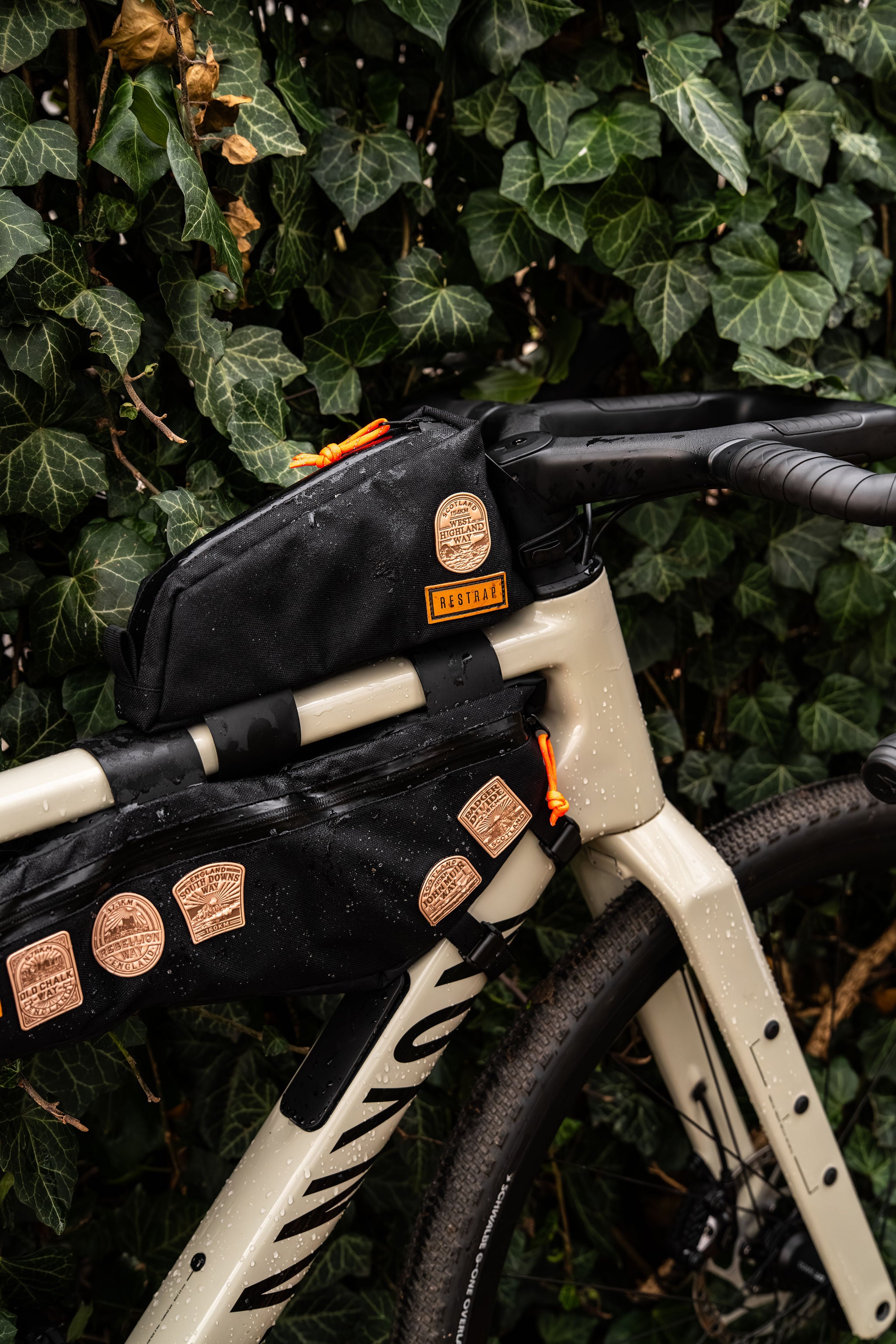 Bikepacking patches flat-lay including King Alfred's Way - retro woven cycling route patches
