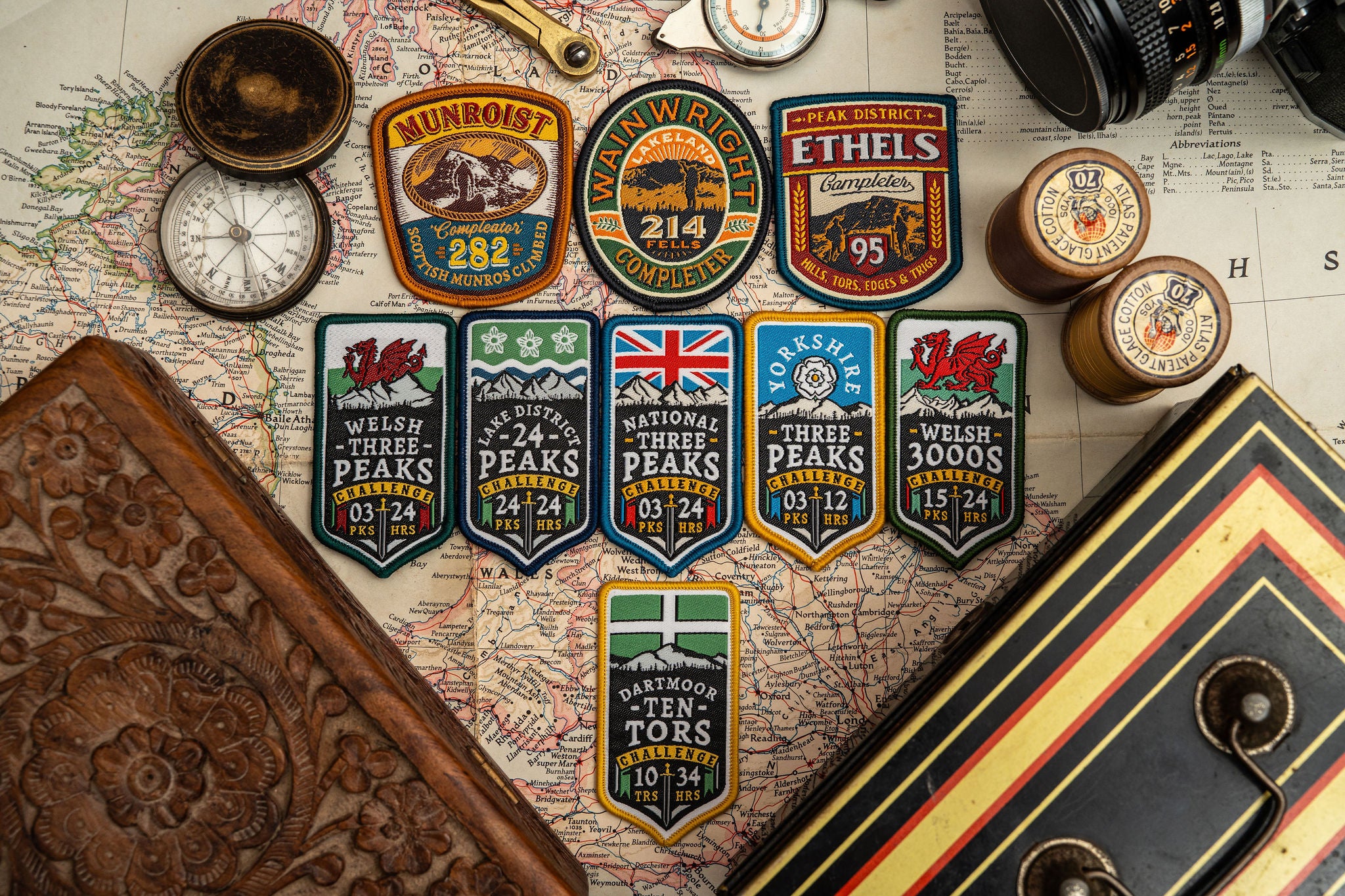 Adventure Patch Company challenge patches displayed together – woven hiking and hillwalking patches
