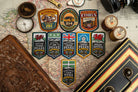 Adventure Patch Company challenge patches displayed together – woven hiking and hillwalking patches