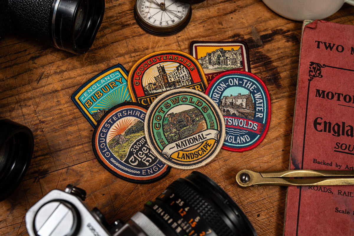 Cleeve Hill patch styled on outdoor gear - retro woven Cotswolds hiking patch in an outdoor setting