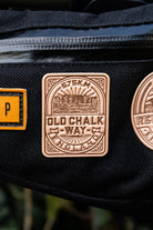 Bikepacking patches flat-lay including Old Chalk Way - retro woven cycling route patches