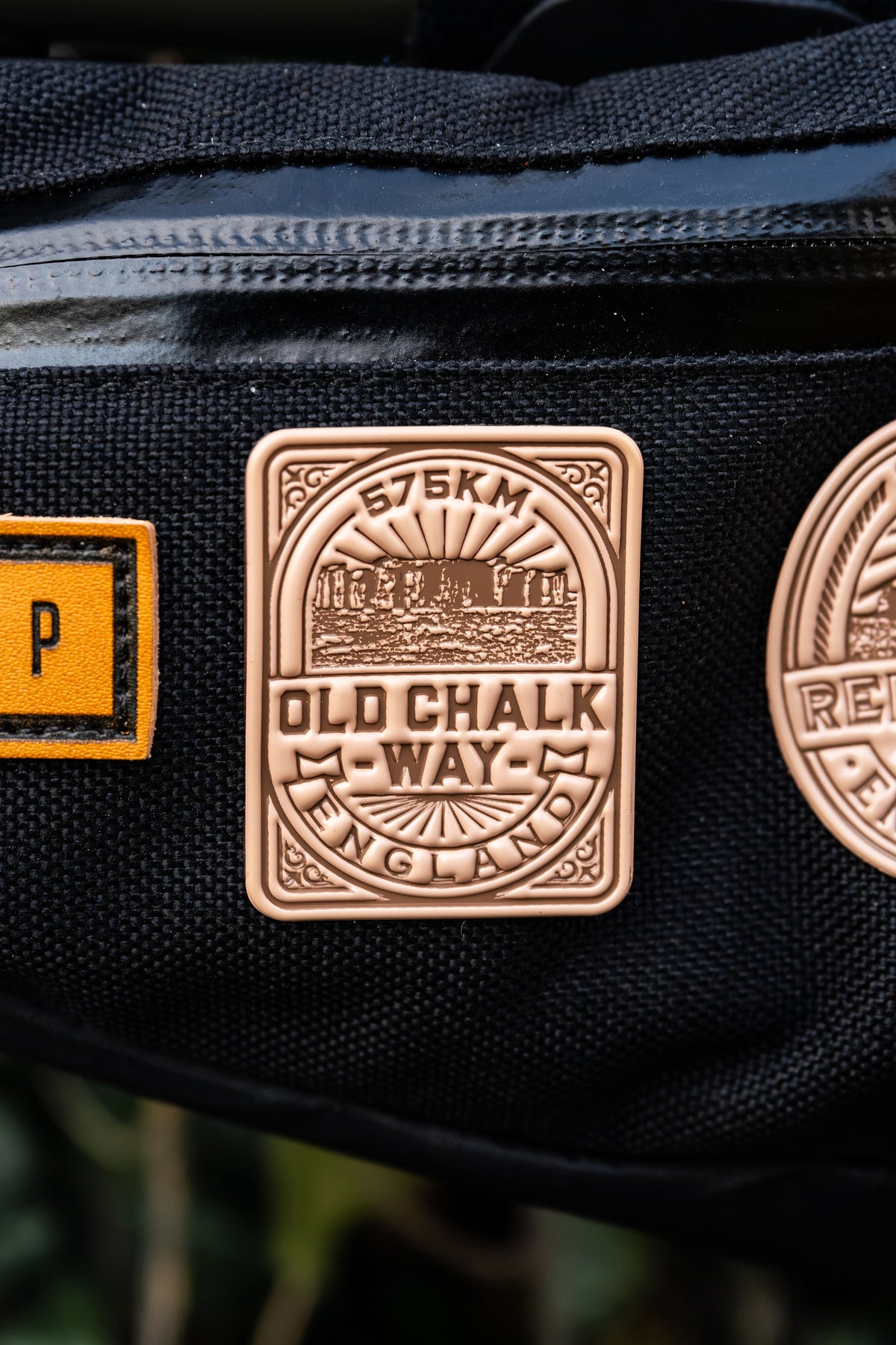 Bikepacking patches flat-lay including Old Chalk Way - retro woven cycling route patches