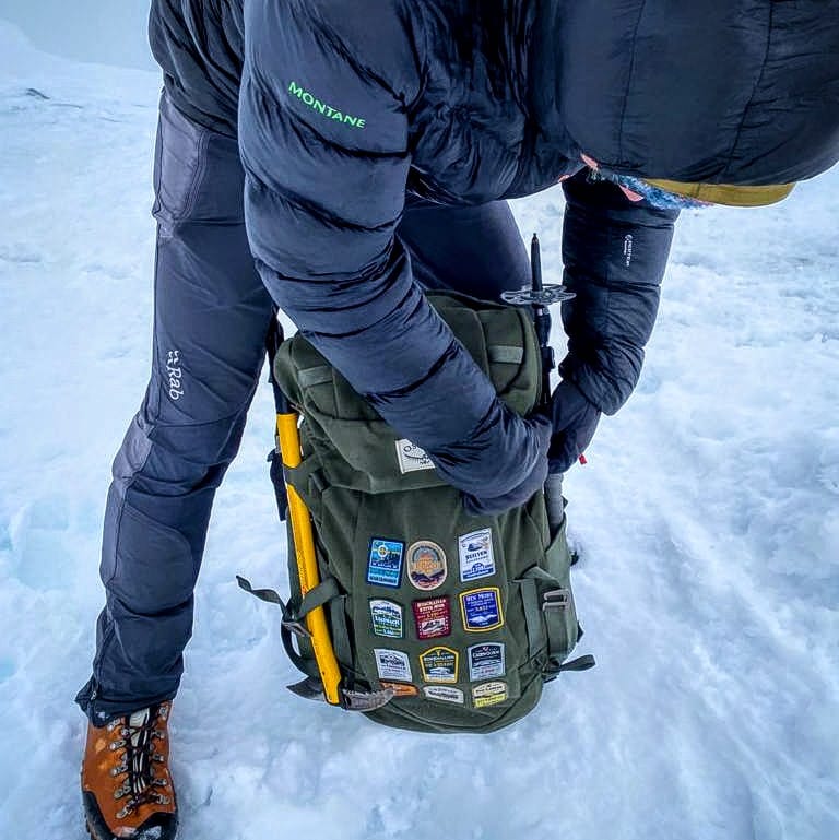 Scottish patches on a rucksack in the snow – Isle of Skye patch included in winter outdoor collection