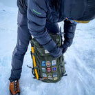 Scottish patches on a rucksack in the snow – Isle of Skye patch included in winter outdoor collection