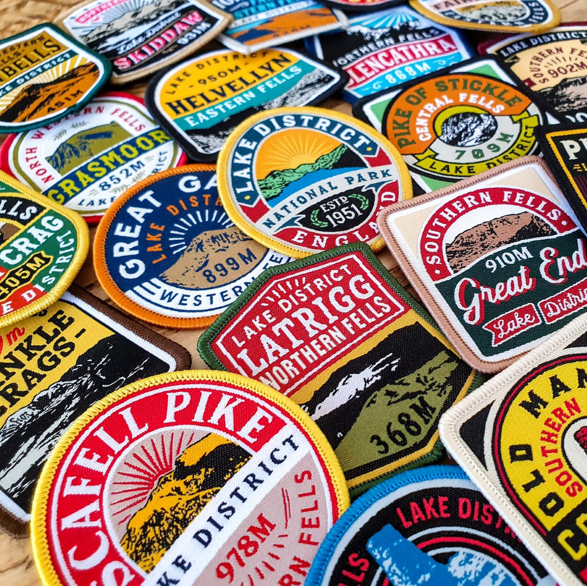 Lake District Fells collection patches spread on outdoor gear – full set of 30 woven patches