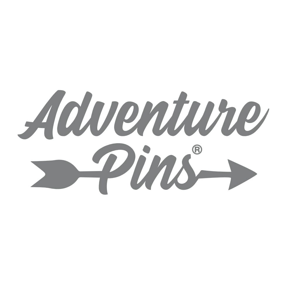 UK National Park enamel pins on a pack – Pembrokeshire Coast pin included in outdoor collection