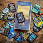 Peak District patches on a desk – Dovedale patch included in collection display