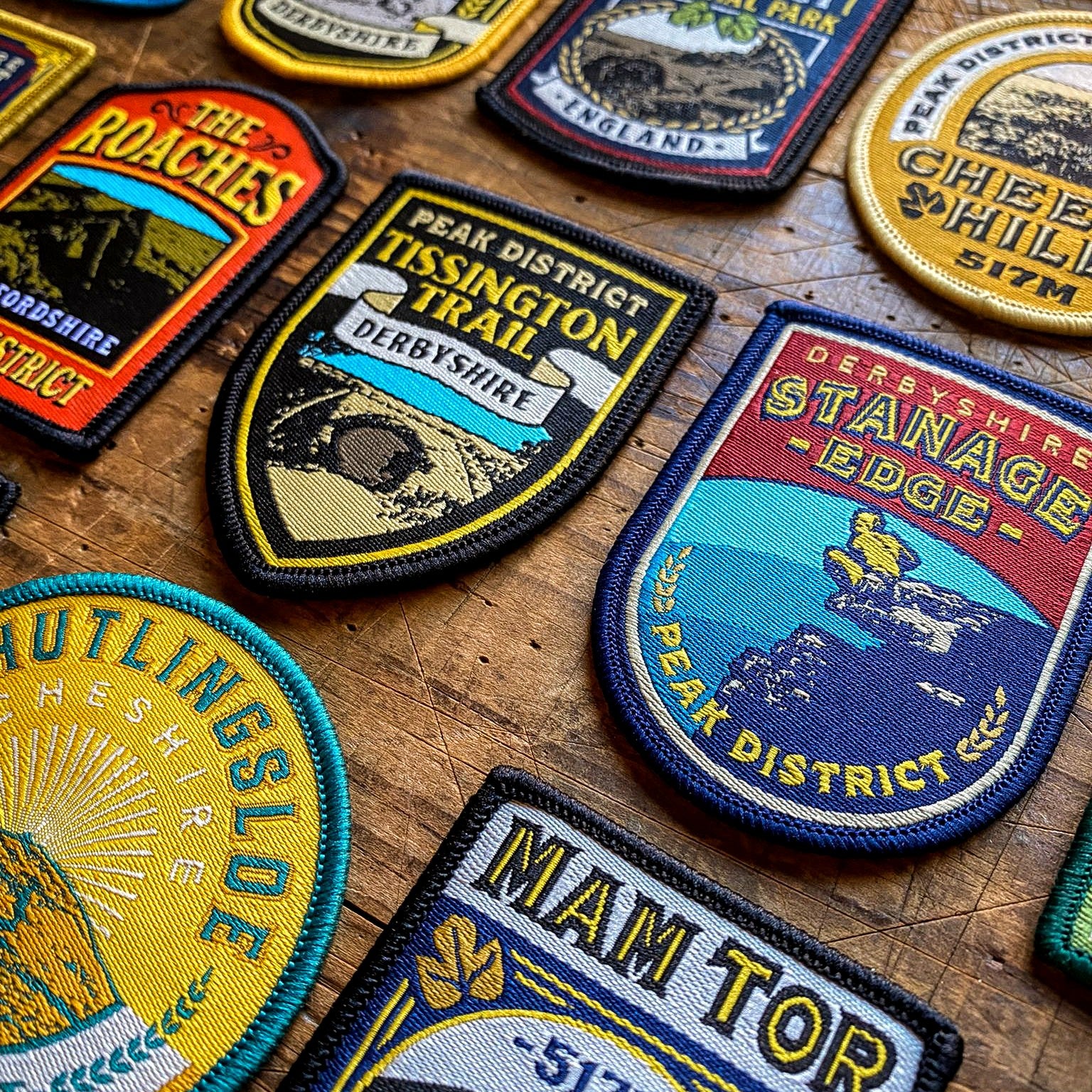 Peak District patches display including Black Hill – pub sign retro woven patch collection on desk