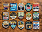 Welsh Mountain patches full set of 15 laid out on a surface – Celtic design retro woven hiking patches
